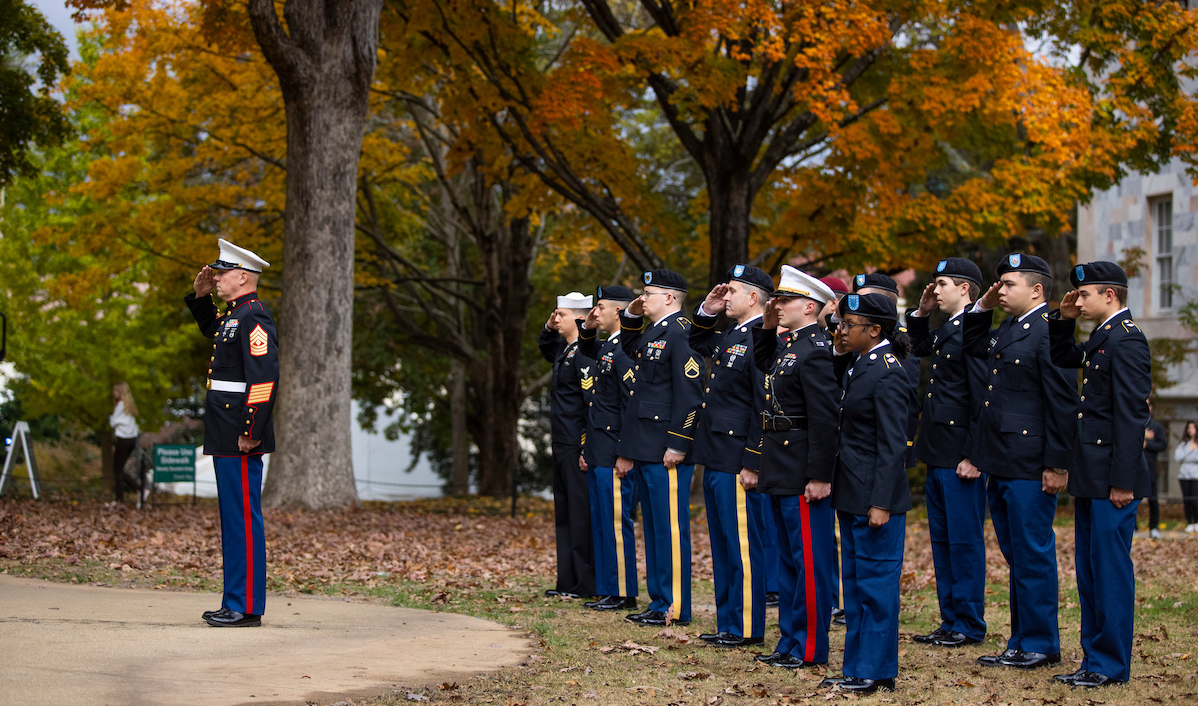 students in uniform saluting