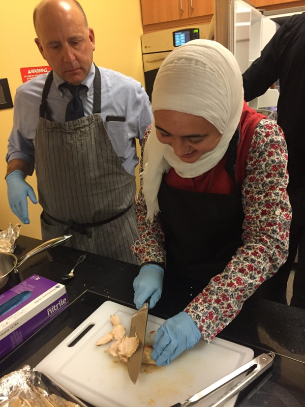 Reem Al-Attasi learns to cut turkey medallions