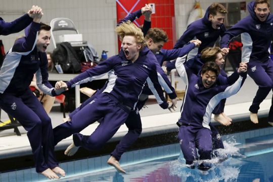 swimmers jumping into pool